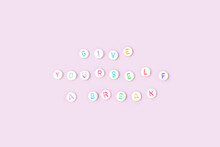 Give Yourself A Break. Quote Made Of White Round Beads With Colorful Letters On A Purple Background. Selfcare Concept.