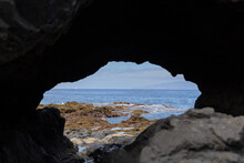 View To The Ocean Through Hole In The Cliff.