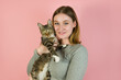 © piksik - Young happy girl holding cute cat.Animal shelter concept.