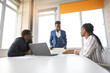 © Alexandr - team of african successful people behind a laptop