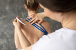 © Татьяна Волкова - Closeup rearview female doctor, therapist taping stripes on back muscles, Kinesio taping as treatment. Patient backache