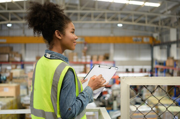 Wall Mural - Female warehouse worker Counting items in an industrial warehouse on the factory's mezzanine floor. which is a storage for small and light electronic parts.