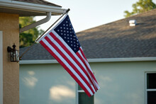 American Flag Waving On The Corner Of Private Residential House, Symbol Of Patriotism