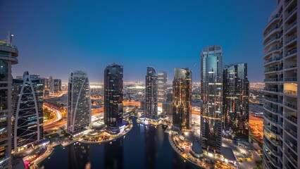 Wall Mural - Tall residential buildings at JLT aerial day to night timelapse, part of the Dubai multi commodities centre mixed-use district.