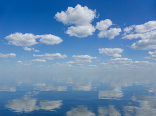 Wall Mural - sky and water. a calm landscape of clouds reflecting in the water