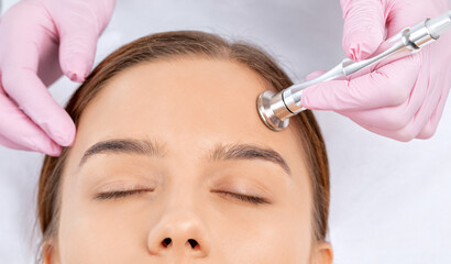 Wall Mural - Procedure microdermabrasion on the face against acne and blackheads. Women's cosmetology in the beauty salon.