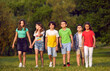 © Studio Romantic - Several teenagers boys and girls from elementary school walking with friends smiling stepping forward have fun taking break between lessons or summer vacation in park. Children portrait