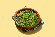 Green Peas With Serrano Ham And Carrot On Yellow Background