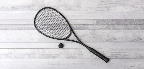 Wall Mural - Black squash racket and ball on grey court. Horizontal sport theme poster, greeting cards, headers, website and app