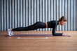 Leinwandbild Motiv Fit woman working on abdominal muscles doing plank exercise, core workout.