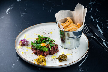 Wall Mural - Steak tartar raw minced beef meat served with french fries potato chips