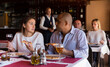 © JackF - Young hispanic couple enjoying dinner with delicious pizza and wine in cozy italian restaurant