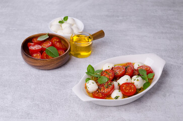 Tomato slices with cheese balls and spicy oil