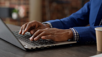 Wall Mural - Project manager developing business charts on laptop to plan strategy, using paperwork report with statistics on internet app. Company employee working on online website. Close up.