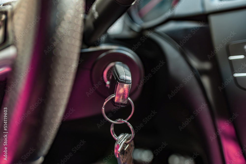 Key inserted into the lock of ignition of the car.Car ignition key.Car key in the ignition. Black key in the lock ignition close-up. Modern car.Selective focus.