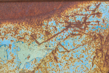 Wall Mural - Rusty metallic textured background with remnants of blue paint.