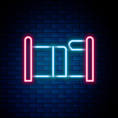 Poster - Glowing neon line Bed icon isolated on brick wall background. Colorful outline concept. Vector