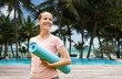 fitness, sport and healthy lifestyle concept - happy smiling woman with exercise mat over swimming pool on tropical beach background in french polynesia