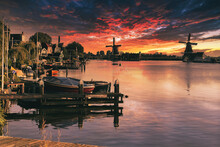 Small Pier With Boats In Holland During Sunset. Colorful Houses And Windmills On The Zaan River. Peace And Silence.