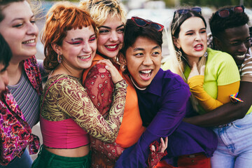young diverse friends having fun outdoor laughing together - focus on asian guy face