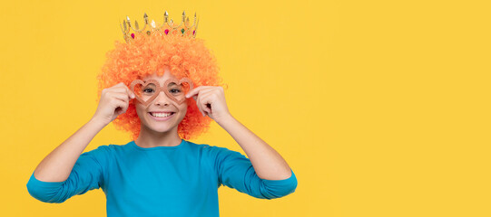 happy teen girl in fancy clown wig wear queen crown and funny party glasses, happiness. Funny teenager child in wig, party poster. Banner header, copy space.