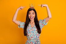 Photo Of Young Cheerful Egocentric Female Showing Her Luxurious Royal Crown Diadem Isolated On Yellow Color Background