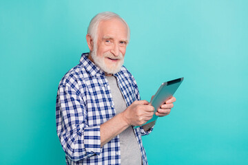 Sticker - Photo of handsome businessman using tablet to watch documents chatting with colleagues isolated on turquoise color background