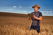 © Xalanx - Farmer with a tablet in a wheat field