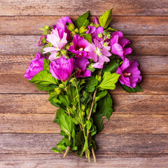 Wall Mural - a bouquet of hibiscus flowers on a vintage wooden background close-up