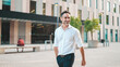 © Andrii Nekrasov - Mature businessman with neat beard wearing white shirt on his way to the office in the financial district in the city. Successful man Looks at the upper floors of modern buildings