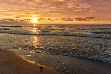 Wall Mural - Sunset on Baltic Sea white bright golden orange color and rough sea