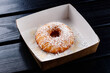 one doughnut in a street food box