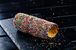 Trdelnik is a traditional sweet cake made from yeast dough held around a stick, then fried and sprinkled with sugar