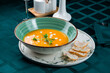 Yellow carrot or pumpkin soup with bread. Healthy eating. Halloween, thanksgiving