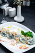 Handmade seafood ravioli with trout and salmon in cream sauce