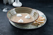 Plate of Cream Cappuccino Soup with Porcini Mushrooms and Truffle on Black Stone