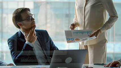 Wall Mural - Mature professional company leader working sitting at boardroom table in office. Startup team discussing project