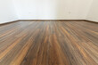 © dechevm - Laminated wood floor with white wall. Empty room with floating laminate in new apartmen