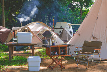 Wall Mural - outdoor kitchen equipment and wooden table set with field tents group in camping area of natural par