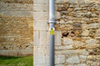 Anti-Climb Paint warning sign seen attached to a newly painted wrought iron drainpipe seen on a church exterior. Used to help prevent lead roof theft in a rural English community.