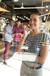 © Wavebreak Media - Biracial smiling businesswoman analyzing charts on glass wall while colleagues in background