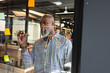 © Wavebreak Media - African american mature businessman planning business strategy on glass wall in creative office