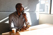 © Wavebreak Media - Thoughtful african american mature businessman with smart phone during coffee break in office