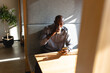 © Wavebreak Media - African american mature businessman using smart phone while having coffee during break in office