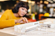 © Wavebreak Media - Biracial young female architect analyzing architectural model in creative office