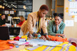 © Wavebreak Media - Multiracial young female fashion designers discussing over fabric in creative office