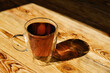 Leinwandbild Motiv Transparent glass cup of hot black tea on wooden table. Morning breakfast concept.