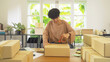 © tampatra - An Asian happy woman girl working online from home, selling product, packing postal parcel packaging carton box delivery, in social media. Online shopping business. SME ecommerce. People lifestyle.