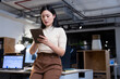 © Wavebreak Media - Low angle view of female asian professional working over digital pc while leaning on desk at night
