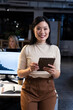 © Wavebreak Media - Portrait of smiling asian female professional working over digital pc in modern office at night